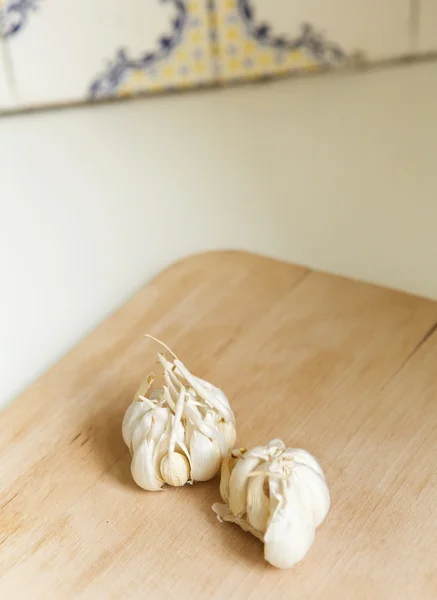 Garlic cloves on wooden chopping board