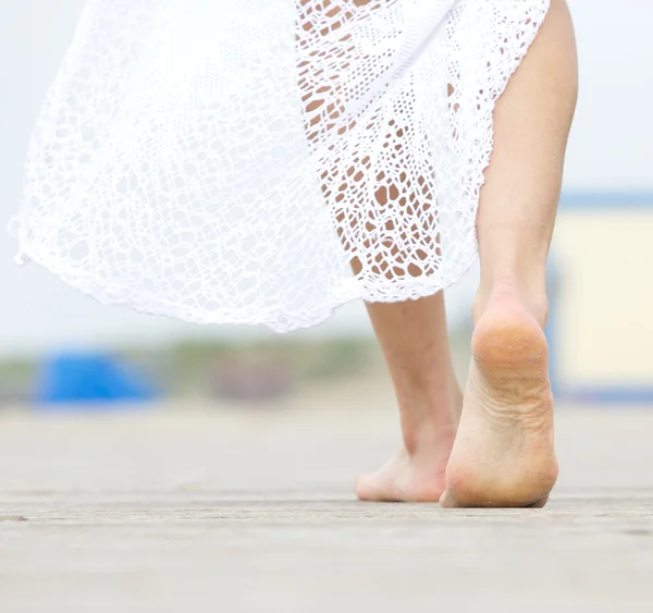 Barefoot woman walking away