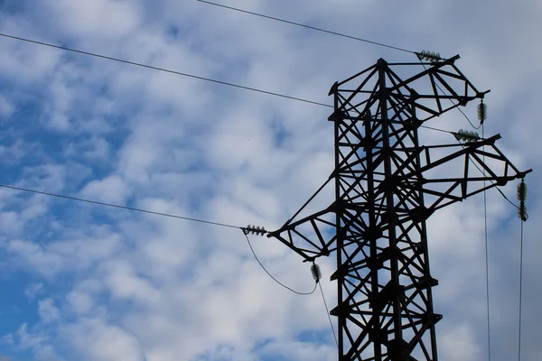 Electric high voltage tower with sky background