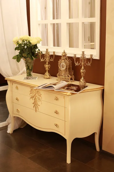 Chest of drawers with old clocks and chandeliers. Plush interior