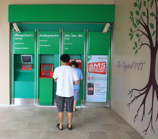 People make money transaction at ATM