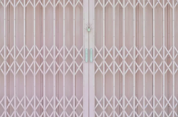 Pink metal grille sliding door with pad lock and aluminium handl