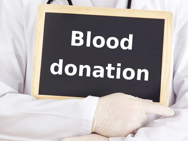 Doctor shows information on blackboard: blood donation