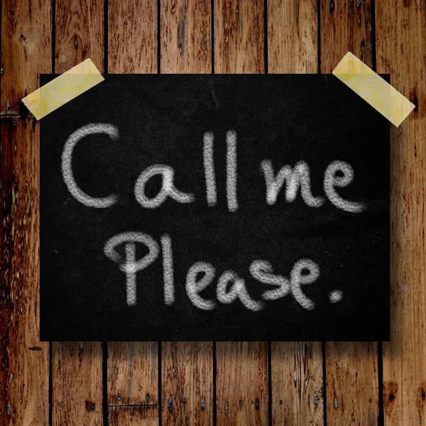 Please call me note on message note with wooden background