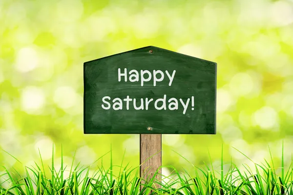 Green sign board with natural background and message Happy saturday