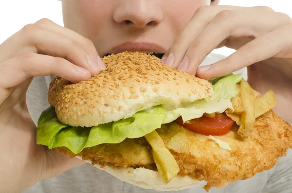 Close up of a man eating a big hamburger, fast food unhealthy burger