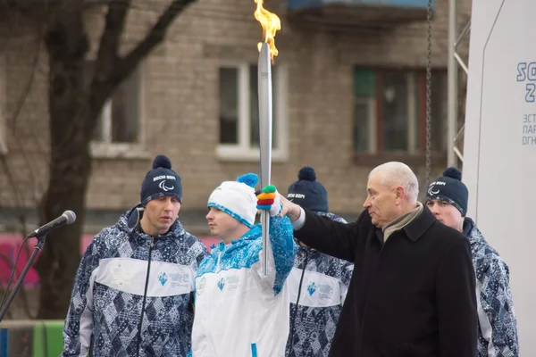 First lighted torch held Tver Mayor Alexander Korzin and athlete