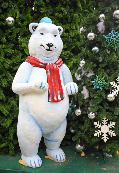 White teddy bear with decorations under the Christmas tree