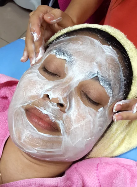 Asian woman with facial mask at a beauty salon