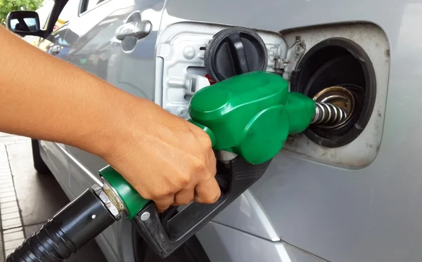 Woman hand refilling the car with fuel