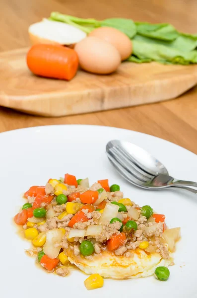 Fried egg topping fried vegetables with minced pork