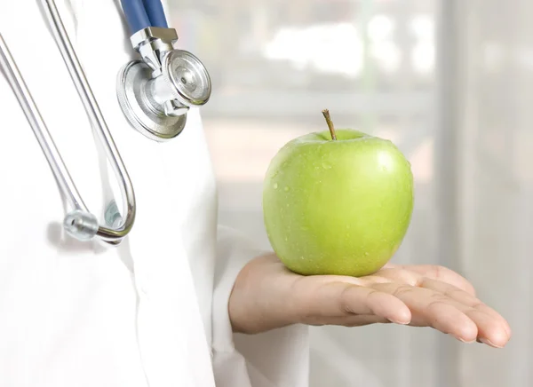 Doctor holding a green apple