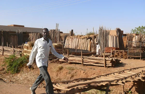 Khartoum, Sudan - 22 November 2008: An unknown man goes on the market. Wood products market. Building materials.