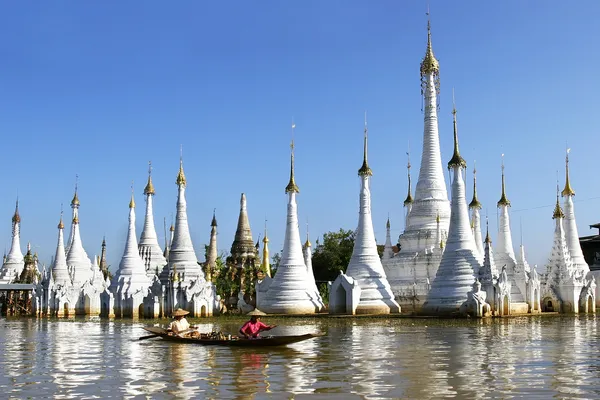 Traditional boat in myanmar on stupa background