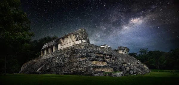 Galactic night starry sky over the ancient Mayan city of Palenqu