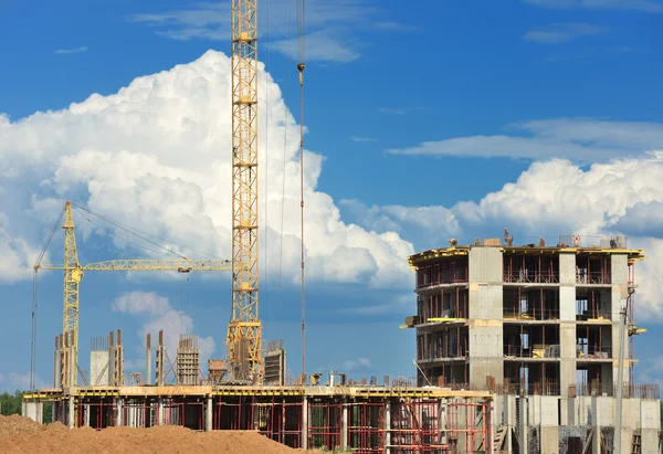 Construction of concrete buildings on background moving clouds i