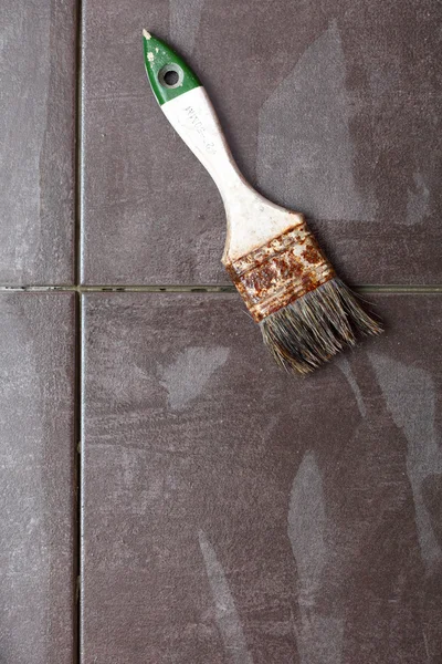 Background Construction brush tiling at home tile floor adhesive