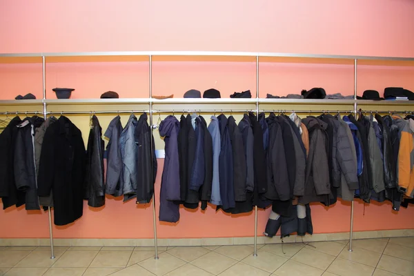 Many clothes in cloakroom — Stock Photo #23717613