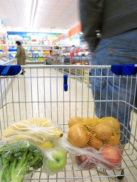 Shopping cart with grocery at supermarket