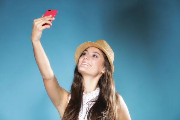 Girl with mobile phone taking photo of herself