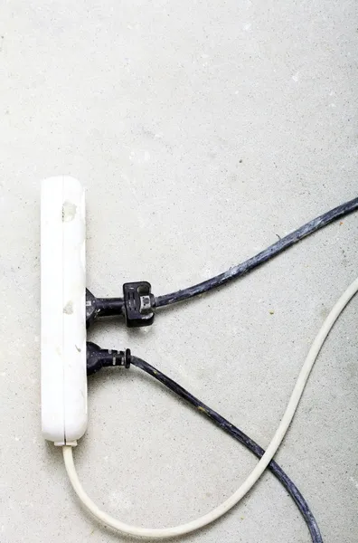 Electrical cords connected to power strip building site