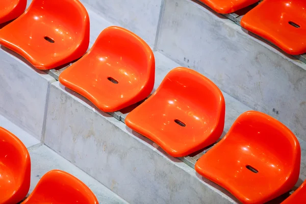 Closeup of red sport stadium seats. Empty stand. Team sport supporter