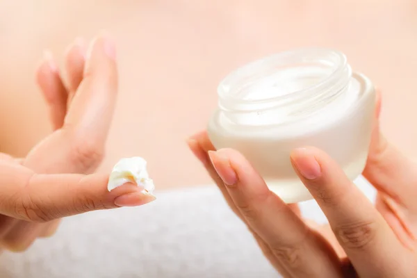 Skin care. Moisturizing cream in female hands