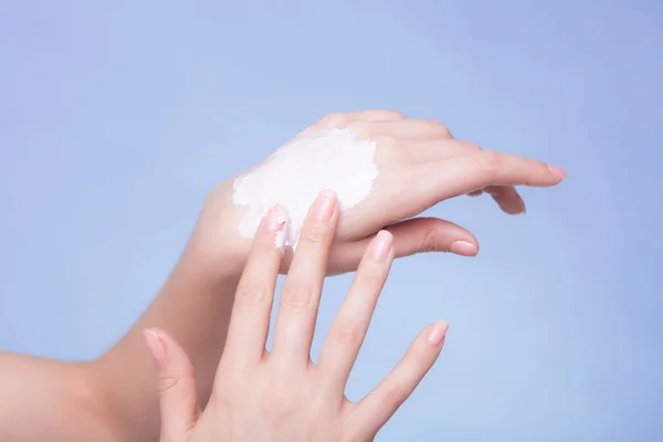 Female palms with moisturizing cream.