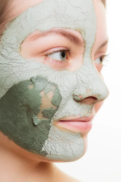 Woman in clay mud mask on face. Beauty.