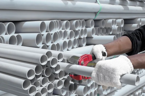 Worker cut pvc pipe in construction site