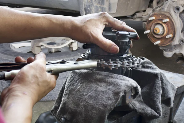 Car mechanic fixing parts of automobile
