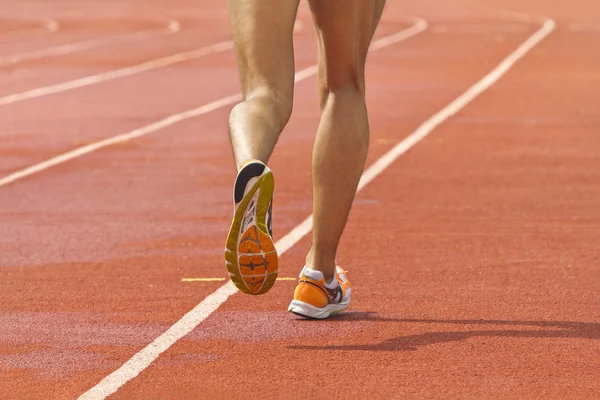 Athlete running at a track and field stadium