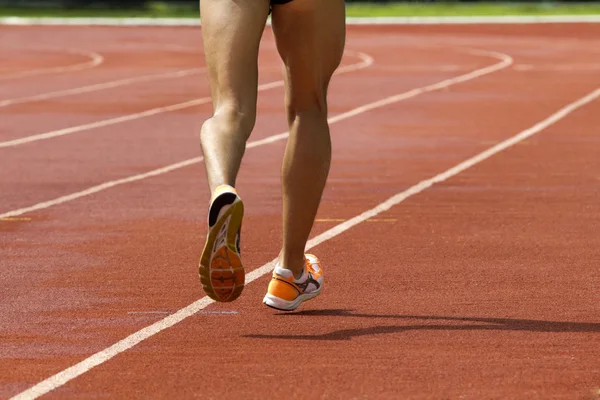 Male running at a track and field stadium