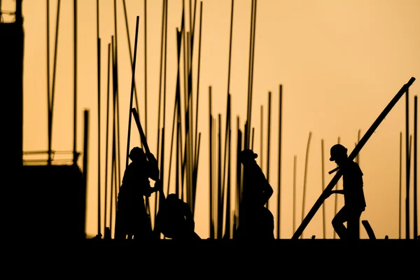 Construction worker silhouette on the work place