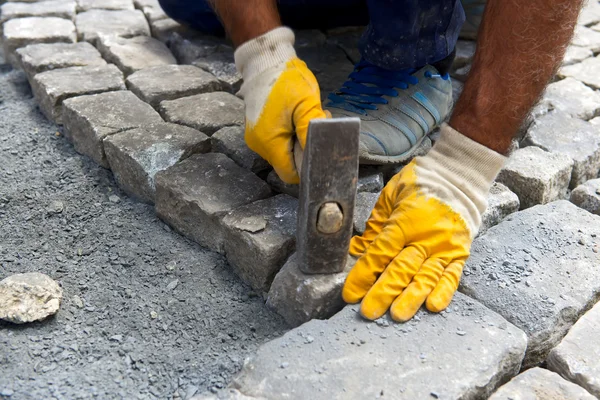Worker make stone pavement