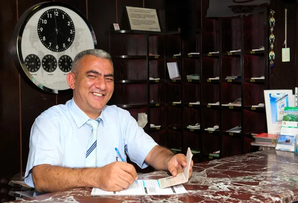 Positive hotel manager at the reception