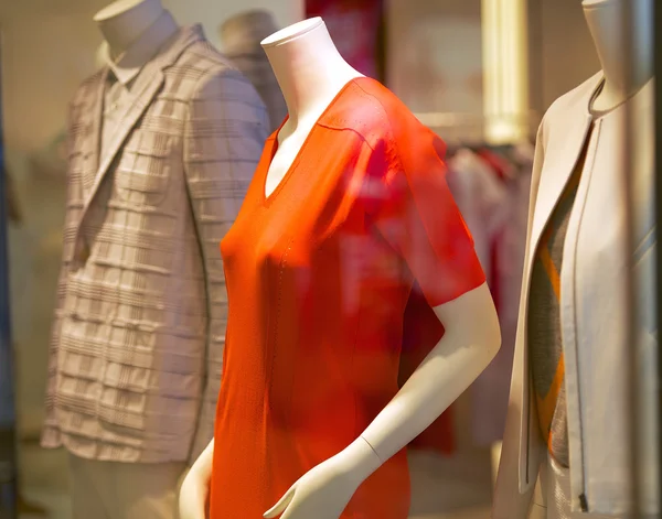 Mannequins in fashionable clothes in the shop window