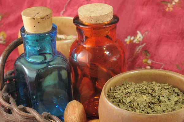 Vintage medical bottles and a mix of dry herbs
