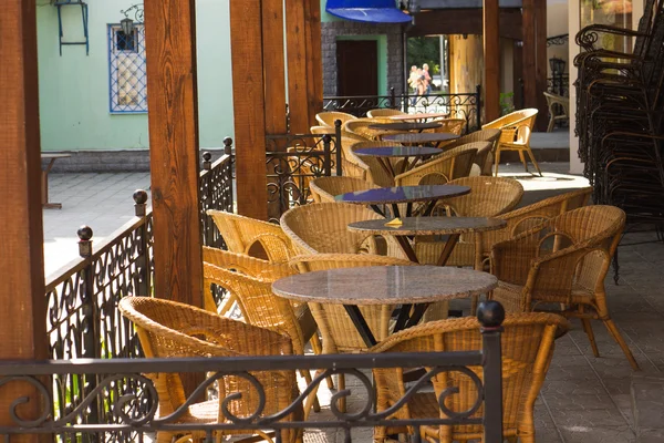 Street cafe with wicker chairs in morning