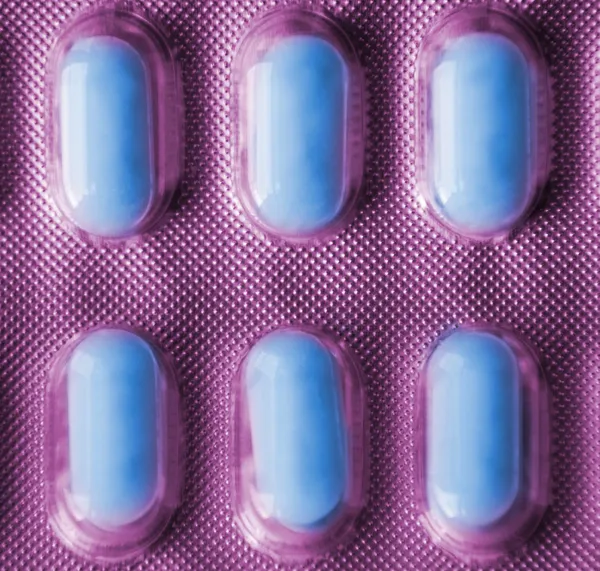 Packs of pills isolated on violet background