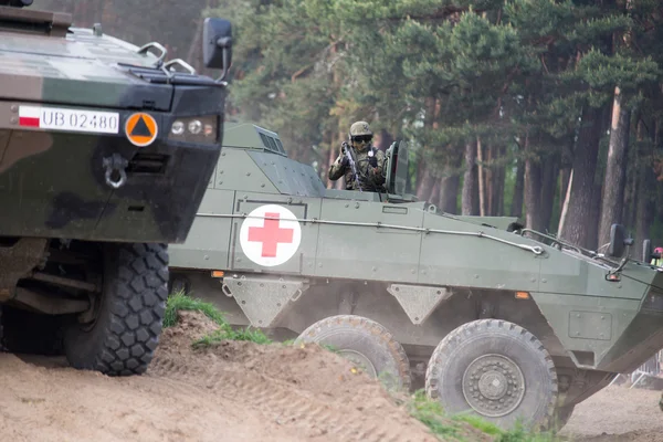 Wroclaw, Poland - May 10. 2014:  AMV XC-360P Rosomak armored vehicle with armored medical support on Military show on May 10, 2014 in Worclaw, Poland