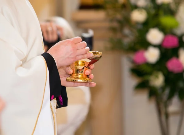 Catholic priest granting the Communion