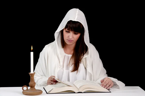 Reading woman in white, with candle