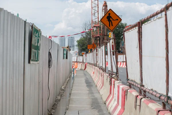 Walkway with safety fenced in construction zone