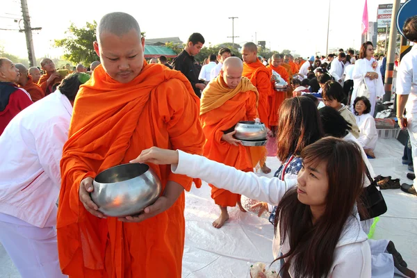 Many people give food and drink for alms to 12,999 Buddhist monks on December 30,2012 in Chiang mai,Thailand.