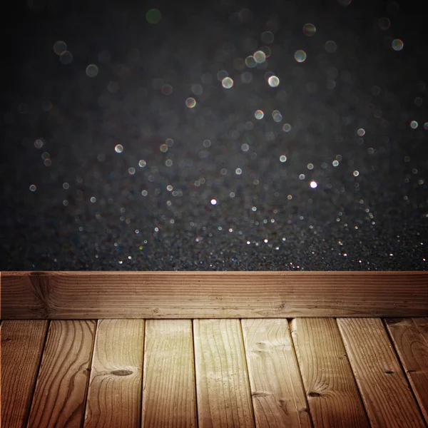 Black glitter lights and wooden floor planks