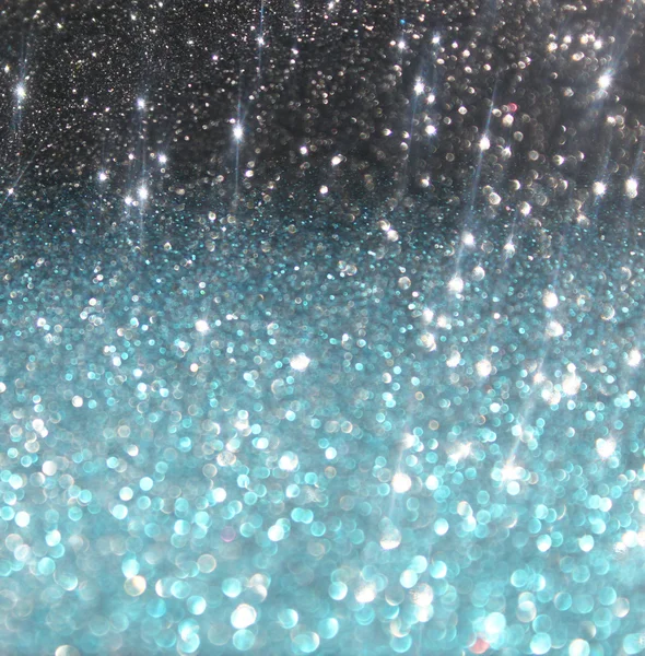 Glitter vintage lights background. blue and black. defocused