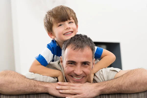 Boy Lying On Father's Back