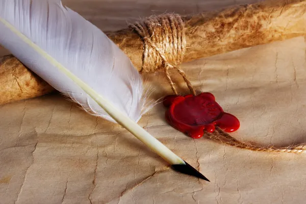 Old paper, ancient parchment scroll, envelope with wax seal and quill pen