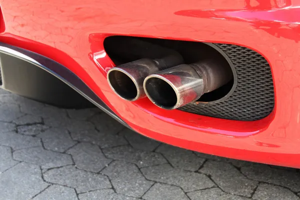 Emission pipe of a red car